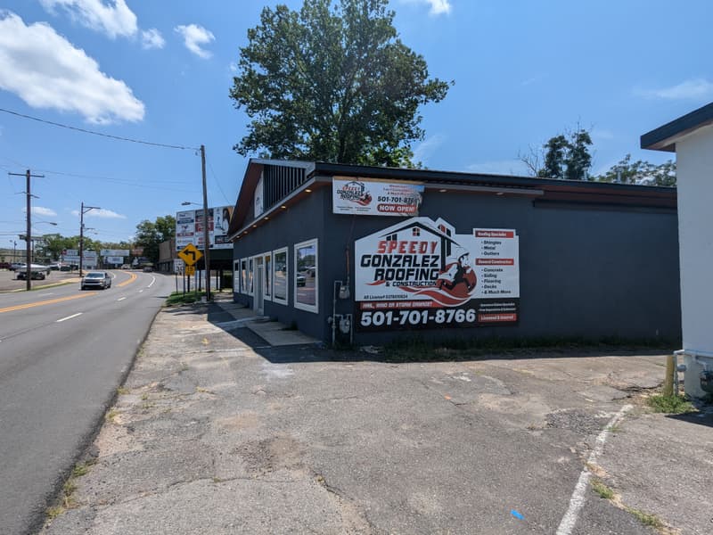 The Speedy Gonzalez Roofing shop on Albert Pike Rd in Hot Springs, Arkansas, with the company sign on the wall
