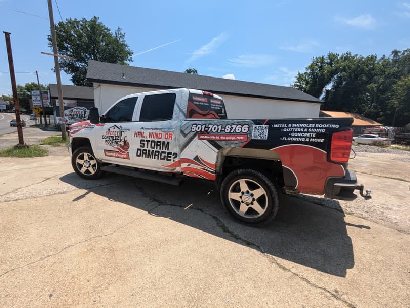 Speedy Gonzalez Roofing wrapped work truck reading Hail, Wind or Storm Damage with the 207 Albert Pike Rd, Hot Springs address